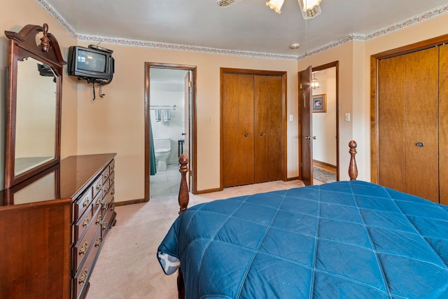6955 N Dowagiac Ave, Chicago, IL 60646 - bedroom featuring multiple closets, ensuite bathroom, and light colored carpet