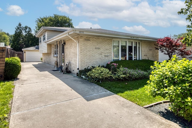 6955 N Dowagiac Ave, Chicago, IL 60646 - split level home with brick siding, an outdoor structure, and a garage