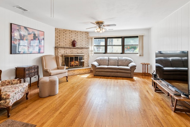 6955 N Dowagiac Ave, Chicago, IL 60646 - living room with a ceiling fan, light wood-type flooring, and a brick fireplace