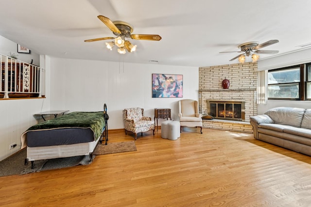 6955 N Dowagiac Ave, Chicago, IL 60646 - living area featuring a ceiling fan, wood finished floors, and a brick fireplace