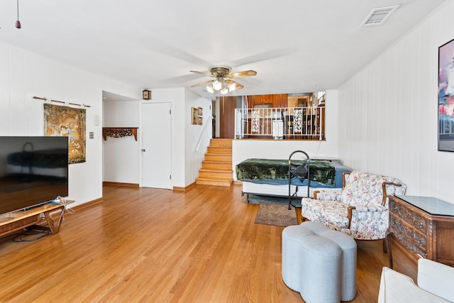 6955 N Dowagiac Ave, Chicago, IL 60646 - living area with wood finished floors, ceiling fan, and stairway