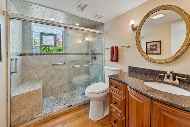 6955 N Dowagiac Ave, Chicago, IL 60646 - full bathroom with vanity, a shower stall, and wood finished floors