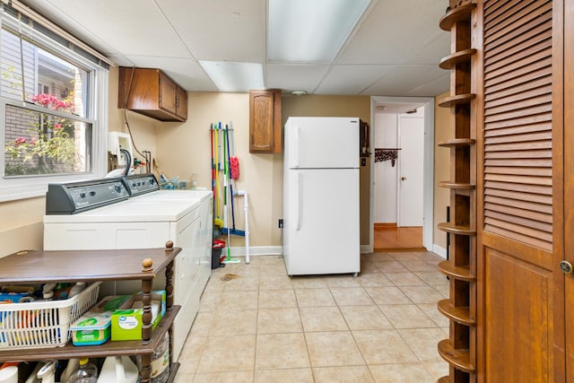 6955 N Dowagiac Ave, Chicago, IL 60646 - laundry area with cabinet space, separate washer and dryer, and light tile patterned floors