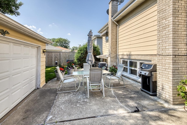6955 N Dowagiac Ave, Chicago, IL 60646 - view of patio with a garage, grilling area, and outdoor dining space