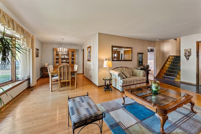 6955 N Dowagiac Ave, Chicago, IL 60646 - living room featuring a chandelier, stairs, and light wood-style floors
