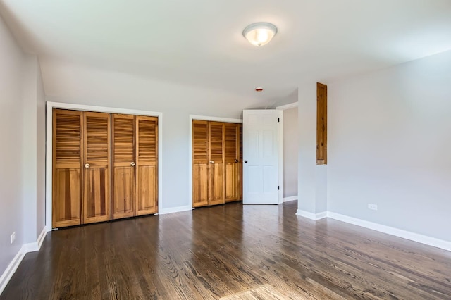 2630 Grunewald St, Blue Island, IL 60406 - unfurnished bedroom with dark wood finished floors and two closets