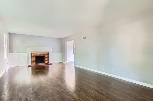 2630 Grunewald St, Blue Island, IL 60406 - unfurnished living room featuring dark wood-type flooring and a brick fireplace