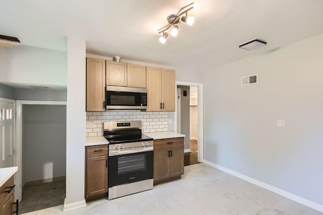 2630 Grunewald St, Blue Island, IL 60406 - kitchen featuring appliances with stainless steel finishes, backsplash, light countertops, and light marble finish floors