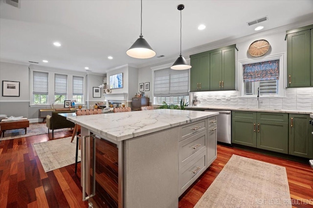 2340 W Roscoe St Unit 2W, Chicago, IL 60618 - kitchen with green cabinets, stainless steel dishwasher, ornamental molding, open floor plan, and a kitchen island