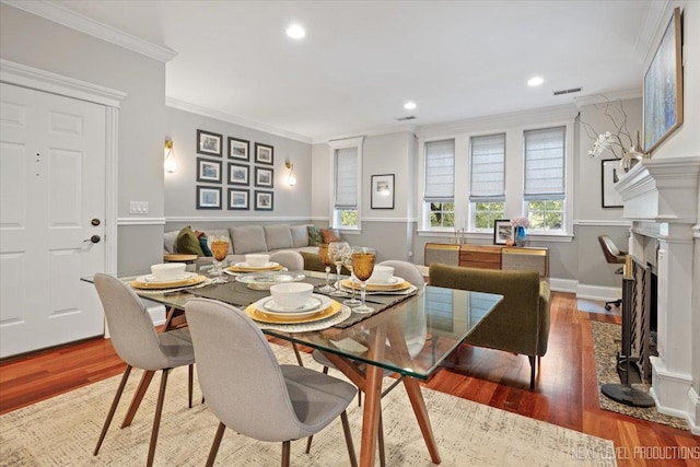2340 W Roscoe St Unit 2W, Chicago, IL 60618 - dining space with crown molding, wood finished floors, a fireplace with flush hearth, and recessed lighting