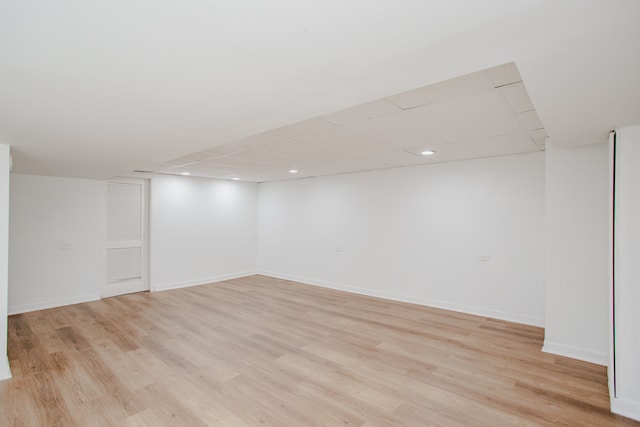 8909 N Washington St Unit E, Niles, IL 60714 - finished basement with light wood-style flooring and a paneled ceiling