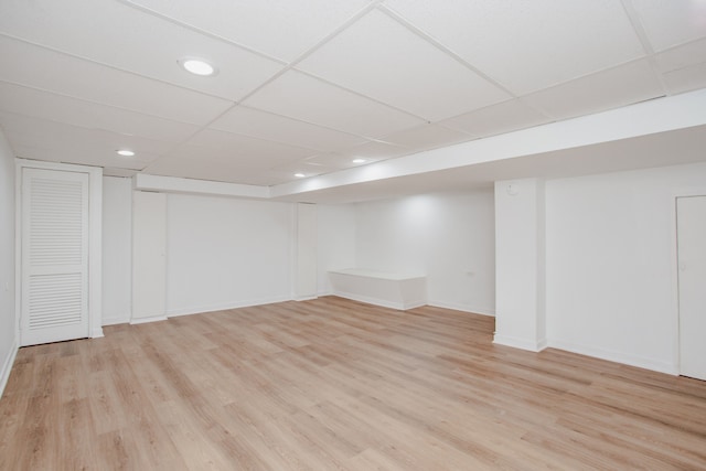8909 N Washington St Unit E, Niles, IL 60714 - finished below grade area featuring light wood-style flooring, recessed lighting, and a paneled ceiling