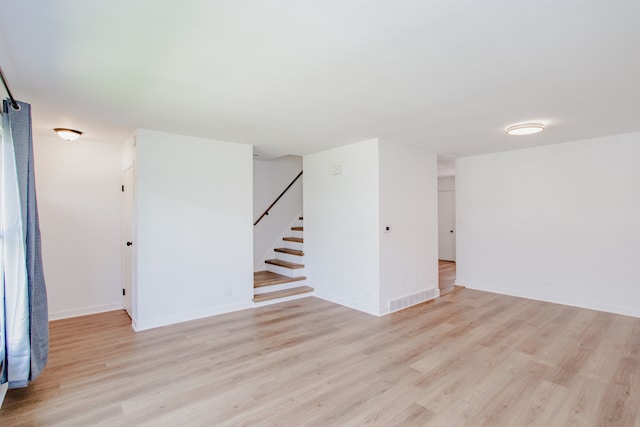 8909 N Washington St Unit E, Niles, IL 60714 - empty room with light wood-style floors and stairway