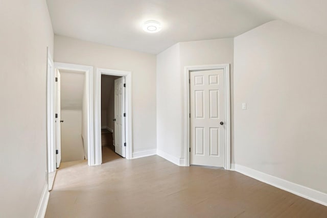 7959 S Saginaw Ave, Chicago, IL 60617 - unfurnished bedroom featuring wood finished floors and vaulted ceiling