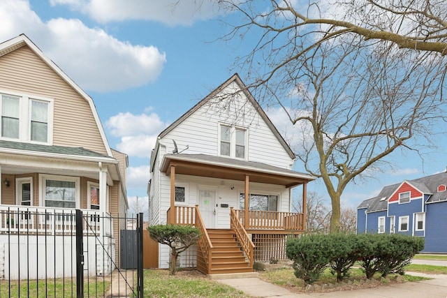 7959 S Saginaw Ave, Chicago, IL 60617 - view of front of house featuring covered porch, stairs, a gambrel roof, and a gate
