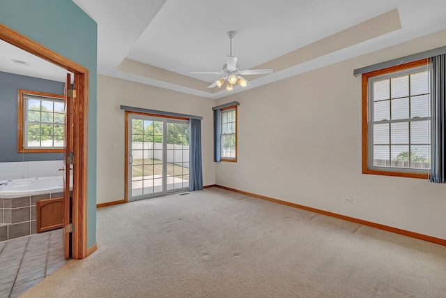 1824 Mia Dr, Crest Hill, IL 60403 - carpeted spare room featuring a tray ceiling, healthy amount of natural light, and ceiling fan