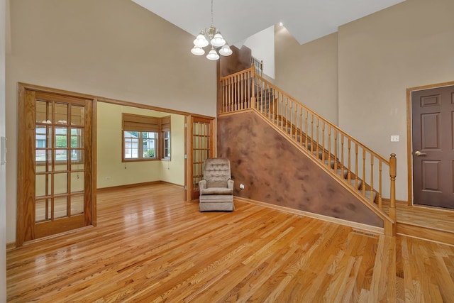 1824 Mia Dr, Crest Hill, IL 60403 - unfurnished living room with a high ceiling, stairway, wood finished floors, and a chandelier