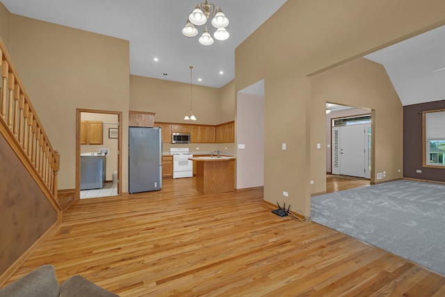 1824 Mia Dr, Crest Hill, IL 60403 - kitchen with stainless steel appliances, open floor plan, high vaulted ceiling, light wood-type flooring, and a chandelier