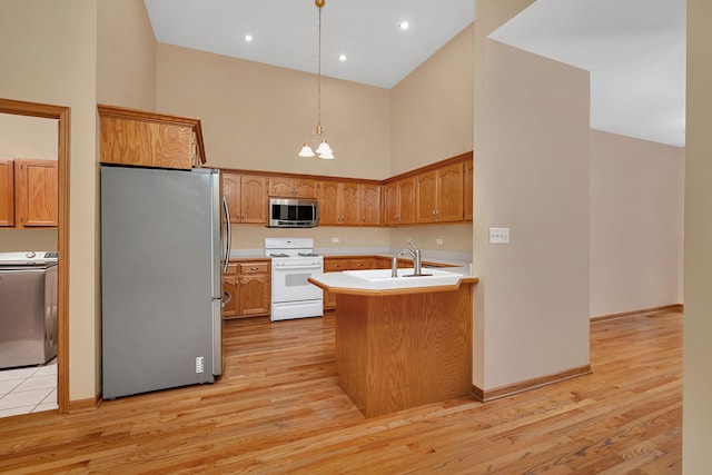 1824 Mia Dr, Crest Hill, IL 60403 - kitchen with stainless steel appliances, washer / dryer, high vaulted ceiling, a chandelier, and light countertops