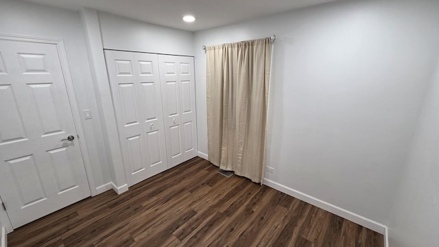 1303 Kingsbury Dr Unit A, Hanover Park, IL 60133 - unfurnished bedroom featuring dark wood-style flooring, recessed lighting, and a closet