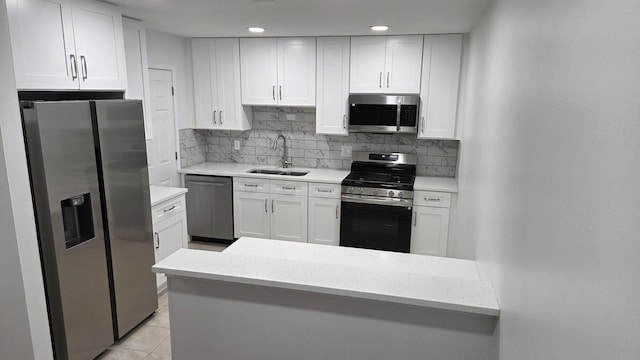 1303 Kingsbury Dr Unit A, Hanover Park, IL 60133 - kitchen with stainless steel appliances, white cabinetry, decorative backsplash, light tile patterned floors, and recessed lighting