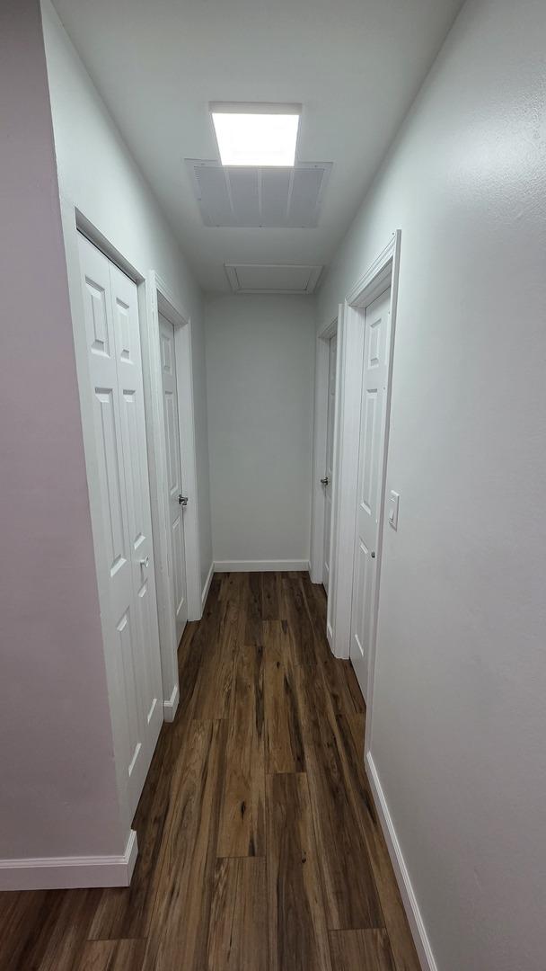 1303 Kingsbury Dr Unit A, Hanover Park, IL 60133 - corridor with dark wood-type flooring