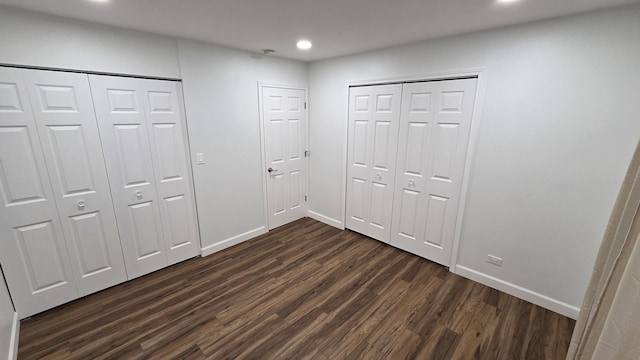 1303 Kingsbury Dr Unit A, Hanover Park, IL 60133 - unfurnished bedroom with dark wood-type flooring, recessed lighting, and multiple closets