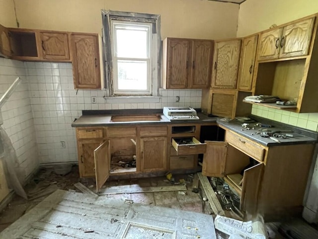 8447 S Escanaba Ave, Chicago, IL 60617 - kitchen featuring tasteful backsplash, brown cabinets, and dark countertops