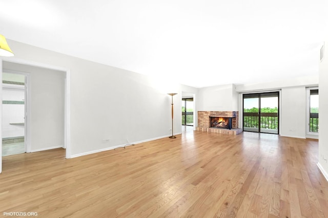 1621 Mission Hills Rd Unit 510, Northbrook, IL 60062 - unfurnished living room with light wood-style floors and a fireplace