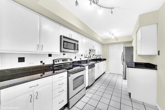 1621 Mission Hills Rd Unit 510, Northbrook, IL 60062 - kitchen with appliances with stainless steel finishes, white cabinets, dark countertops, and backsplash