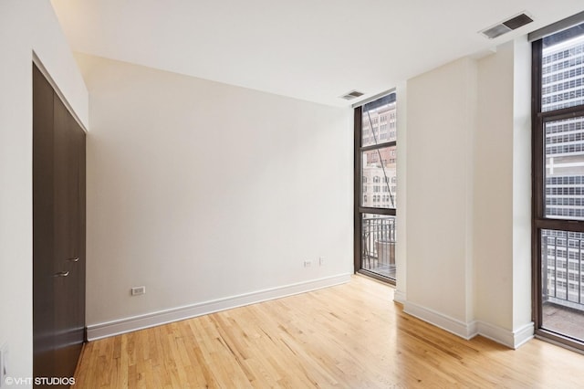 212 W Washington St Unit 1112, Chicago, IL 60606 - empty room with light wood-style floors and baseboards