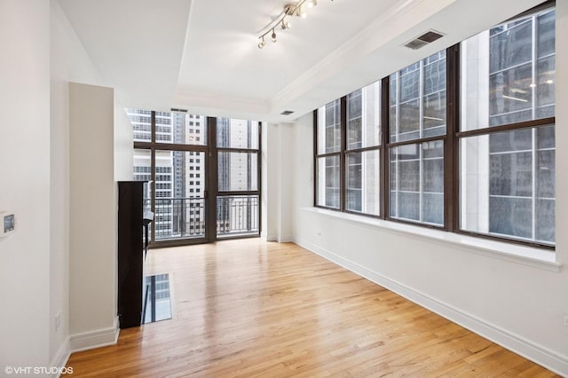 212 W Washington St Unit 1112, Chicago, IL 60606 - unfurnished room with crown molding, wood finished floors, floor to ceiling windows, and track lighting