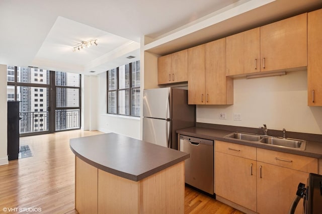 212 W Washington St Unit 1112, Chicago, IL 60606 - kitchen with dishwasher, freestanding refrigerator, dark countertops, light wood-type flooring, and light brown cabinets