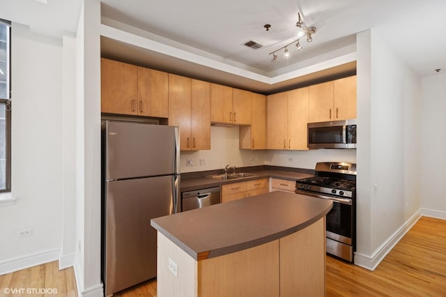 212 W Washington St Unit 1112, Chicago, IL 60606 - kitchen featuring stainless steel appliances, dark countertops, light wood-style flooring, and light brown cabinetry