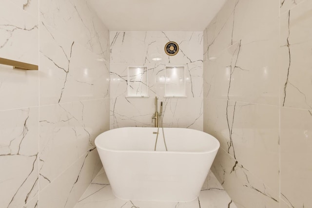 940 W Glenlake Ave Unit 19C, Chicago, IL 60660 - bathroom featuring a freestanding tub, tile walls, and marble finish flooring