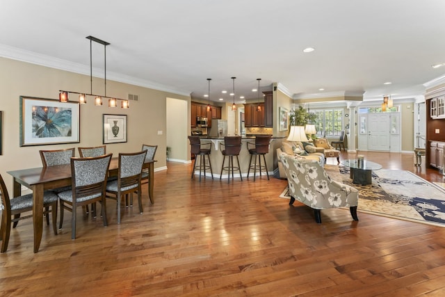 9 Aztec Ct, South Barrington, IL 60010 - living room featuring hardwood / wood-style floors, crown molding, and recessed lighting