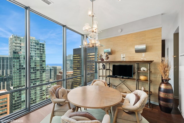 240 E Illinois St Unit 2702, Chicago, IL 60611 - dining space featuring wood finished floors, floor to ceiling windows, and a chandelier