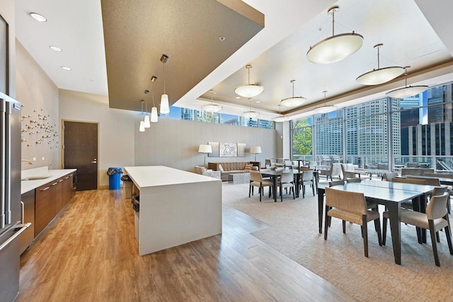 240 E Illinois St Unit 2702, Chicago, IL 60611 - dining room with light wood finished floors, a raised ceiling, and recessed lighting