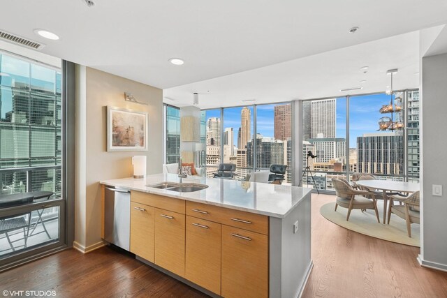 240 E Illinois St Unit 2702, Chicago, IL 60611 - kitchen featuring floor to ceiling windows, a peninsula, dark wood-style flooring, a view of skyline, and stainless steel dishwasher