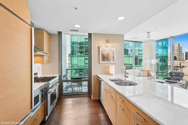 240 E Illinois St Unit 2702, Chicago, IL 60611 - kitchen featuring appliances with stainless steel finishes, floor to ceiling windows, light stone countertops, dark wood-style flooring, and wall chimney range hood