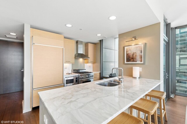 240 E Illinois St Unit 2702, Chicago, IL 60611 - kitchen with wall chimney range hood, built in appliances, modern cabinets, dark wood-style flooring, and recessed lighting