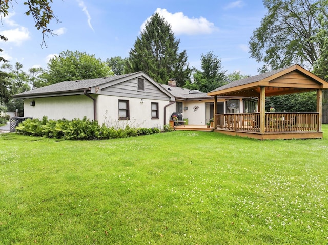 216 Hickory Ct, Northbrook, IL 60062 - rear view of house featuring stucco siding, a wooden deck, a chimney, and a yard