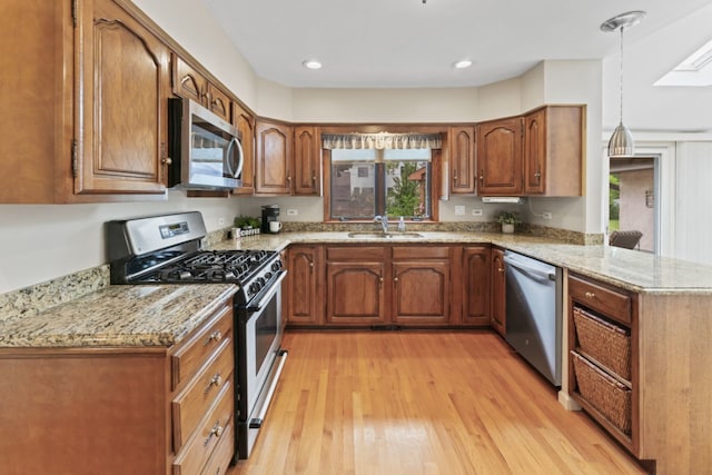 216 Hickory Ct, Northbrook, IL 60062 - kitchen with stainless steel appliances, a peninsula, light wood-style floors, brown cabinetry, and recessed lighting