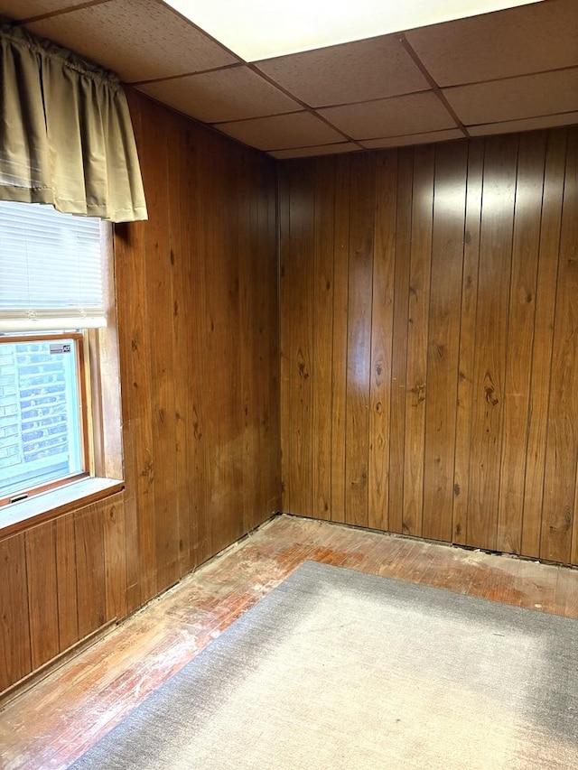 2838 S Keeley St, Chicago, IL 60608 - unfurnished room with a drop ceiling, wood walls, and wood-type flooring