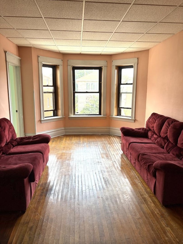 2838 S Keeley St, Chicago, IL 60608 - living room featuring wood-type flooring, a drop ceiling, and plenty of natural light