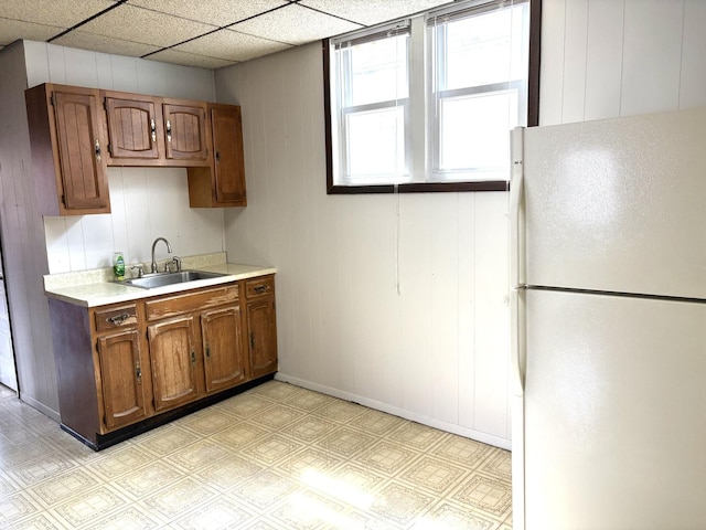 2838 S Keeley St, Chicago, IL 60608 - kitchen featuring freestanding refrigerator, light countertops, light flooring, and brown cabinetry