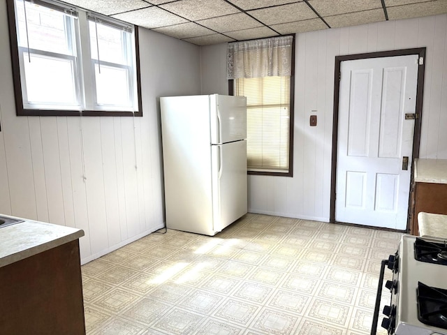2838 S Keeley St, Chicago, IL 60608 - kitchen featuring white appliances, light countertops, light floors, and wood walls