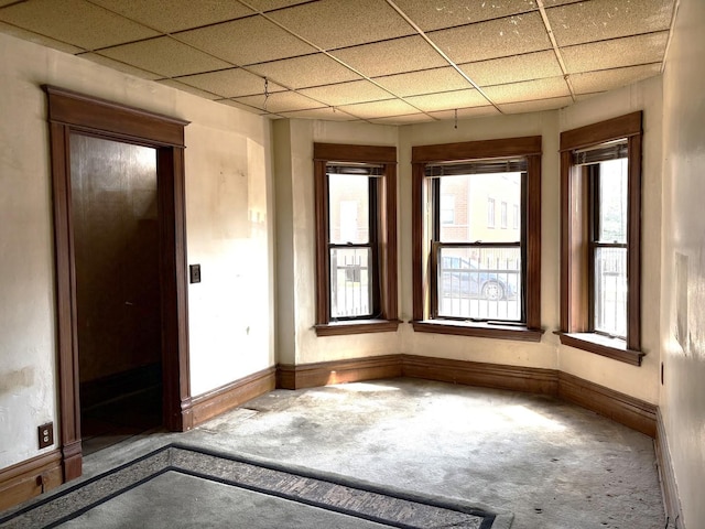 2838 S Keeley St, Chicago, IL 60608 - carpeted empty room with a drop ceiling and plenty of natural light