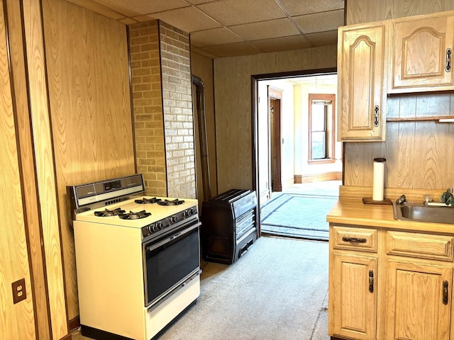 2838 S Keeley St, Chicago, IL 60608 - kitchen with white gas stove, light carpet, light countertops, a drop ceiling, and light brown cabinetry
