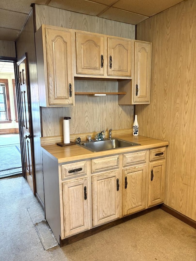 2838 S Keeley St, Chicago, IL 60608 - kitchen featuring light colored carpet, light brown cabinetry, wooden walls, light countertops, and a paneled ceiling